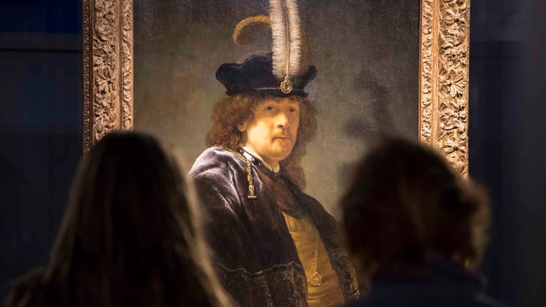 Visitors admire the Rembrandt self-portrait at Buckland Abbey, Devon